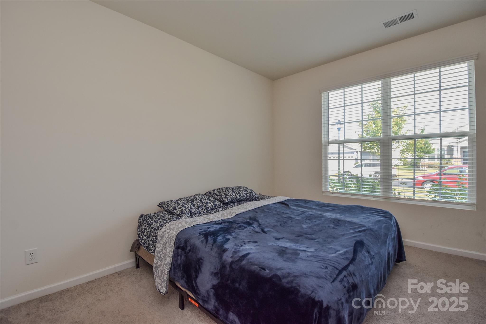 139 West Neel Ranch Road Mooresville, NC 28115 - Photo 15 of 40 a bed sitting in a bedroom next to a window
