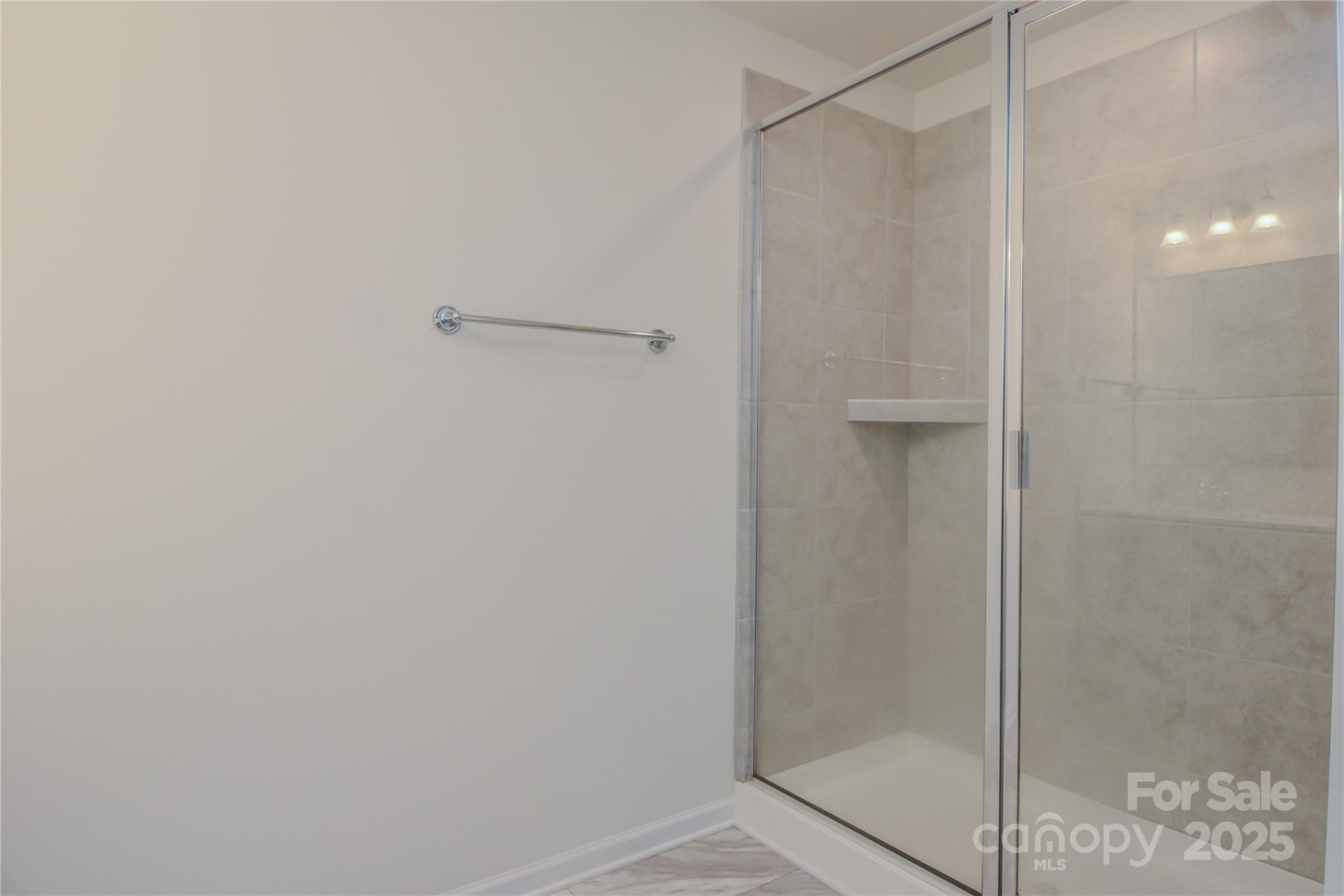 139 West Neel Ranch Road Mooresville, NC 28115 - Photo 21 of 40 a bathroom with a glass shower door