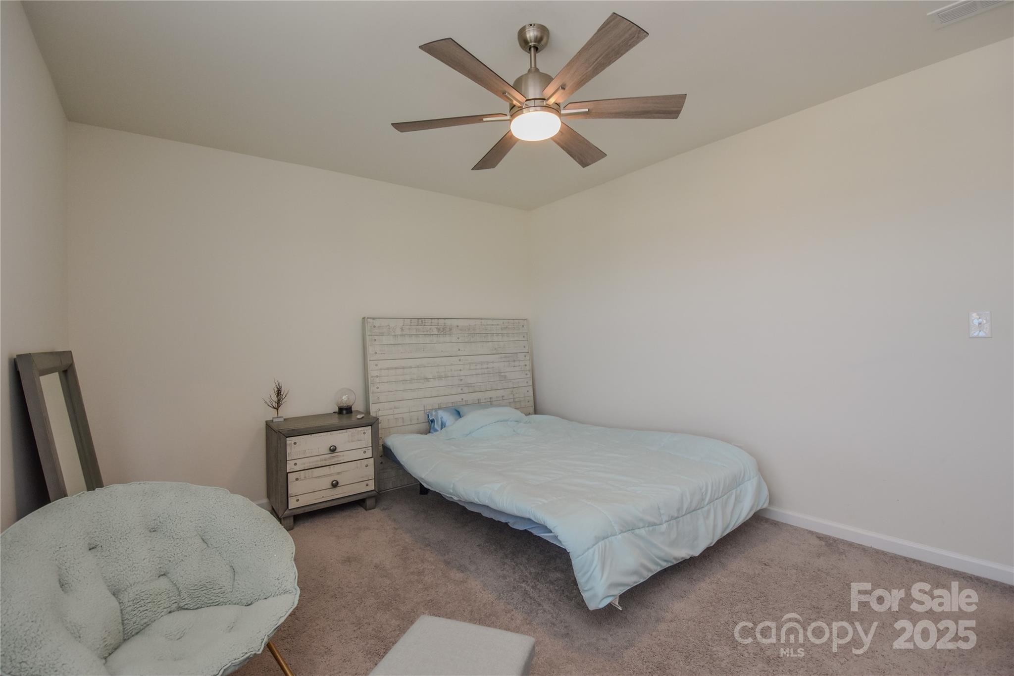 139 West Neel Ranch Road Mooresville, NC 28115 - Photo 27 of 40 a bedroom with a bed and a ceiling fan