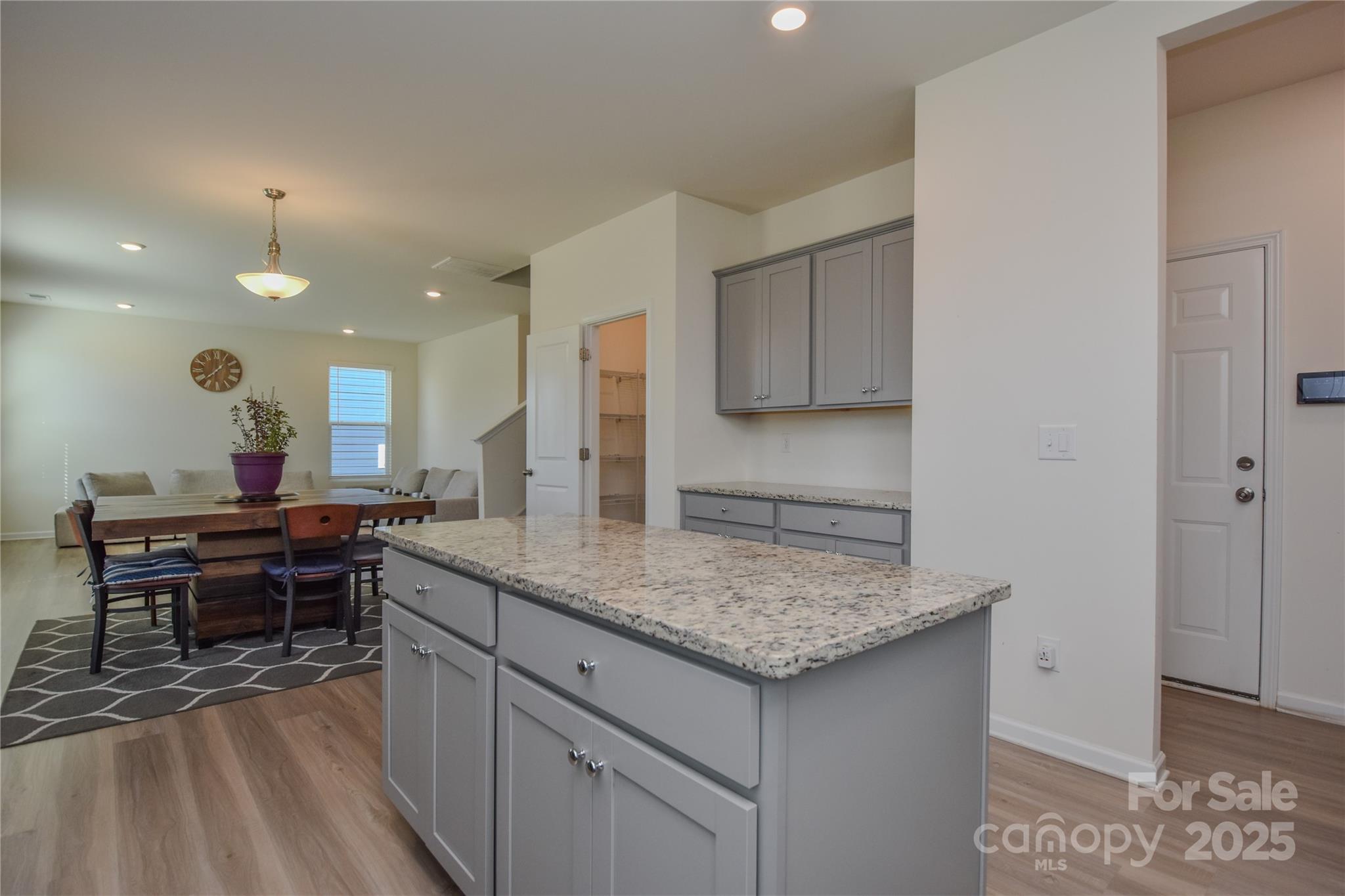 139 West Neel Ranch Road Mooresville, NC 28115 - Photo 9 of 40 a view of kitchen island sink and living room