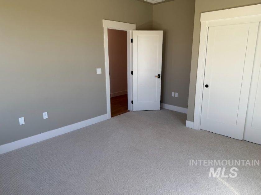 755 West Wrangler Street Meridian, ID 83646 - Photo 18 of 35 Neutral tone wall paint with white trim, carpeting, and two panel doors