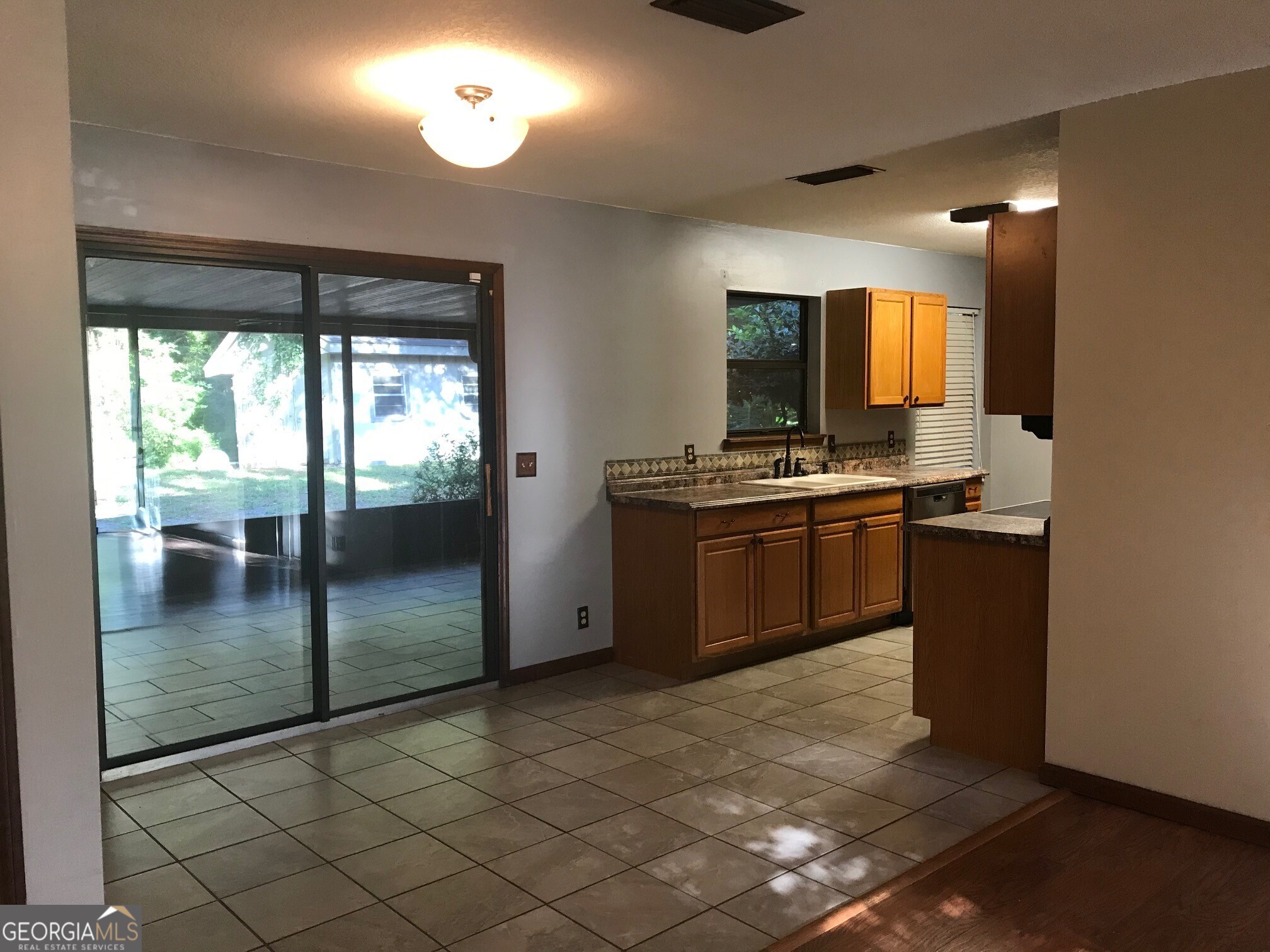 390 Powderhorn Road St. Marys, GA 31558 - Photo 4 of 18 a kitchen with stainless steel appliances granite countertop a stove a sink and a refrigerator