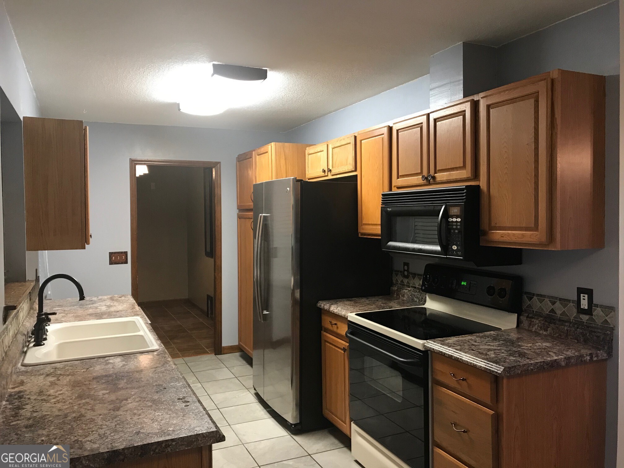390 Powderhorn Road St. Marys, GA 31558 - Photo 5 of 18 a kitchen with stainless steel appliances granite countertop a sink stove and refrigerator