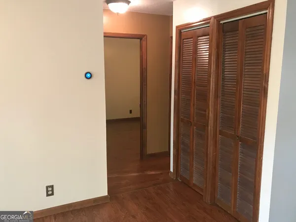 a view of hallway with wooden floor