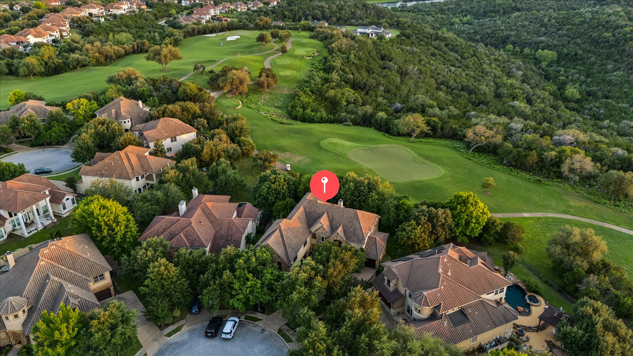 11805 Ranchview Court Austin, TX 78732 - Photo 35 of 36 Aerial perspective showcasing a residential area bordered by expansive golf course greens and natural wooded hillsides
