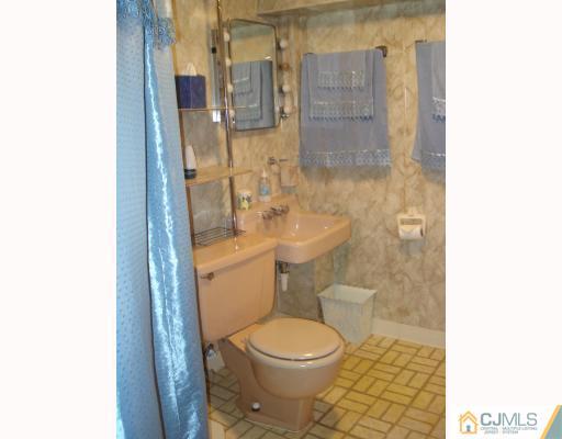 6 Sine Road Edison, NJ 08817 - Photo 8 of 10 a white toilet sitting next to a bathroom sink and a shower