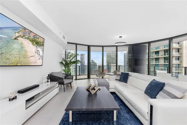 a living room with furniture and a large window