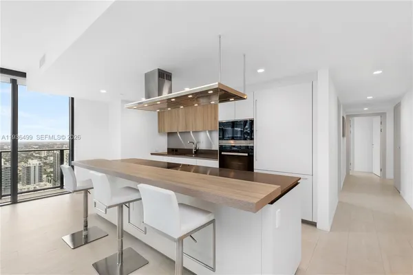 a living room with fireplace furniture and a large window