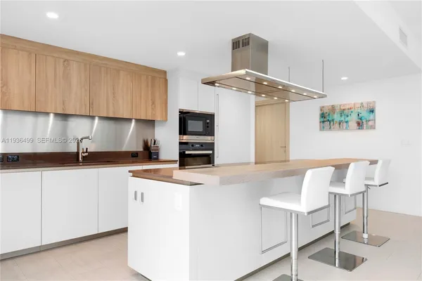 a living room with furniture a window and a potted plant