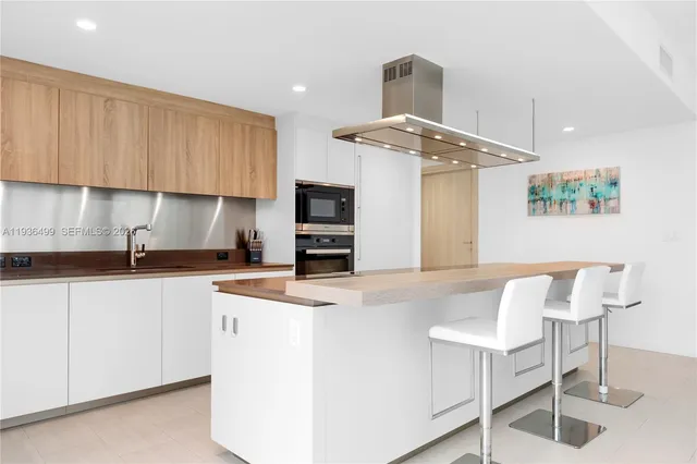 a living room with furniture a window and a potted plant