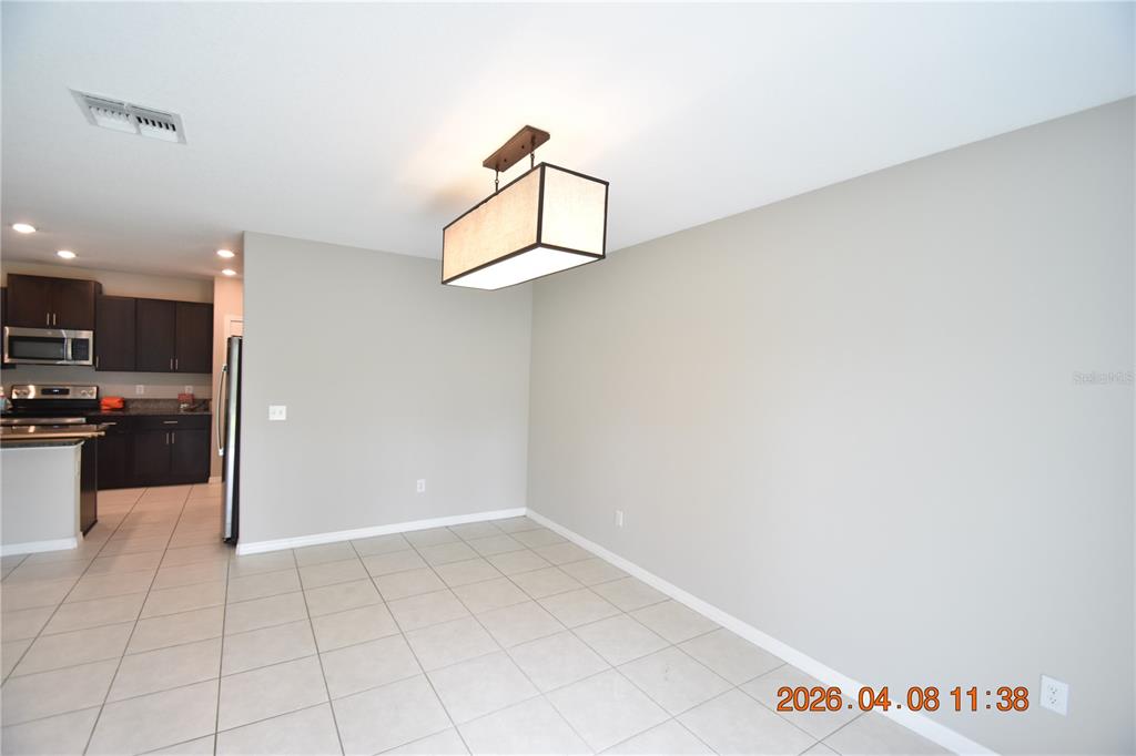 2187 Old Mining Road Lakeland, FL 33801 - Photo 11 of 65 a view of a kitchen with kitchen island wooden cabinets and refrigerator