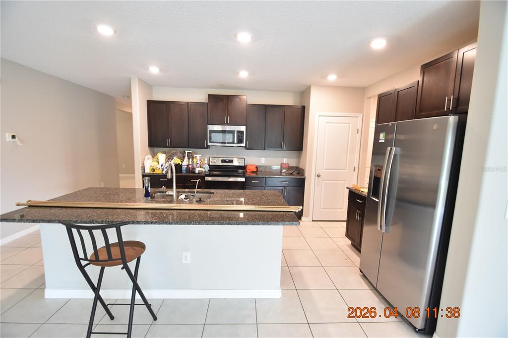 2187 Old Mining Road Lakeland, FL 33801 - Photo 15 of 65 a kitchen with stainless steel appliances granite countertop a refrigerator and a stove top oven