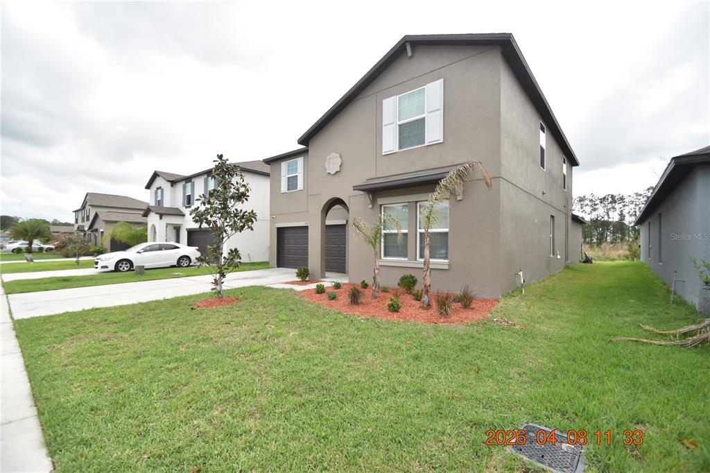 2187 Old Mining Road Lakeland, FL 33801 - Photo 2 of 65 a front view of a house with garden