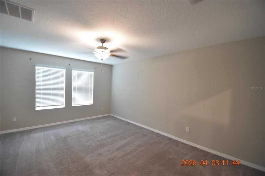 2187 Old Mining Road Lakeland, FL 33801 - Photo 21 of 65 an empty room with windows and chandelier fan