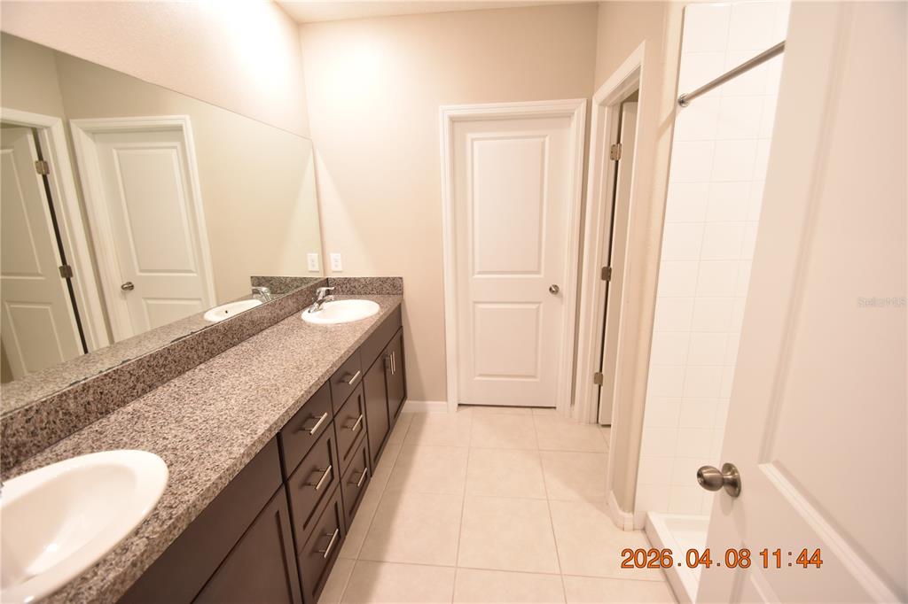 2187 Old Mining Road Lakeland, FL 33801 - Photo 25 of 65 a bathroom with a granite countertop sink and a mirror
