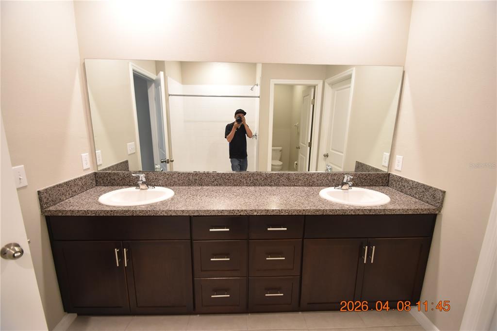 2187 Old Mining Road Lakeland, FL 33801 - Photo 27 of 65 a bathroom with a granite countertop sink and a mirror