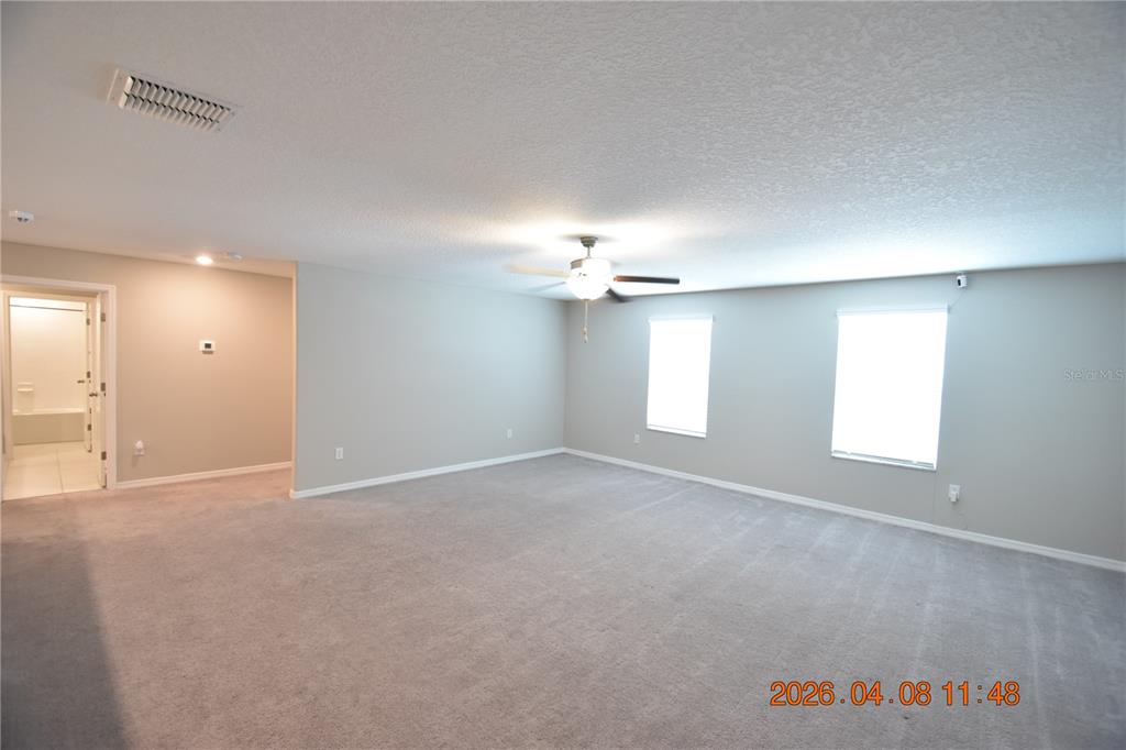 2187 Old Mining Road Lakeland, FL 33801 - Photo 36 of 65 an empty room with windows and chandelier fan
