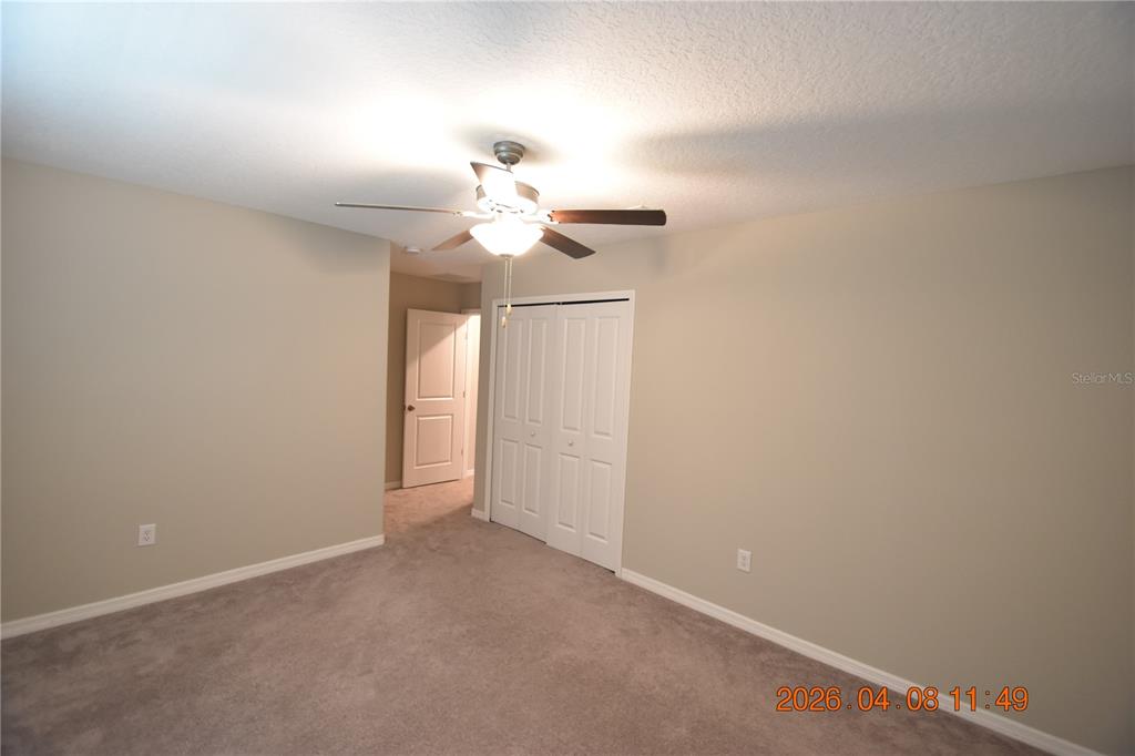 2187 Old Mining Road Lakeland, FL 33801 - Photo 42 of 65 an empty room with a chandelier fan and windows