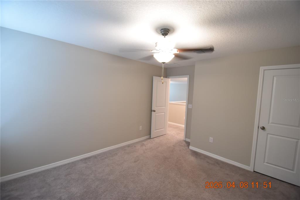 2187 Old Mining Road Lakeland, FL 33801 - Photo 50 of 65 an empty room with a chandelier fan and a chandelier fan