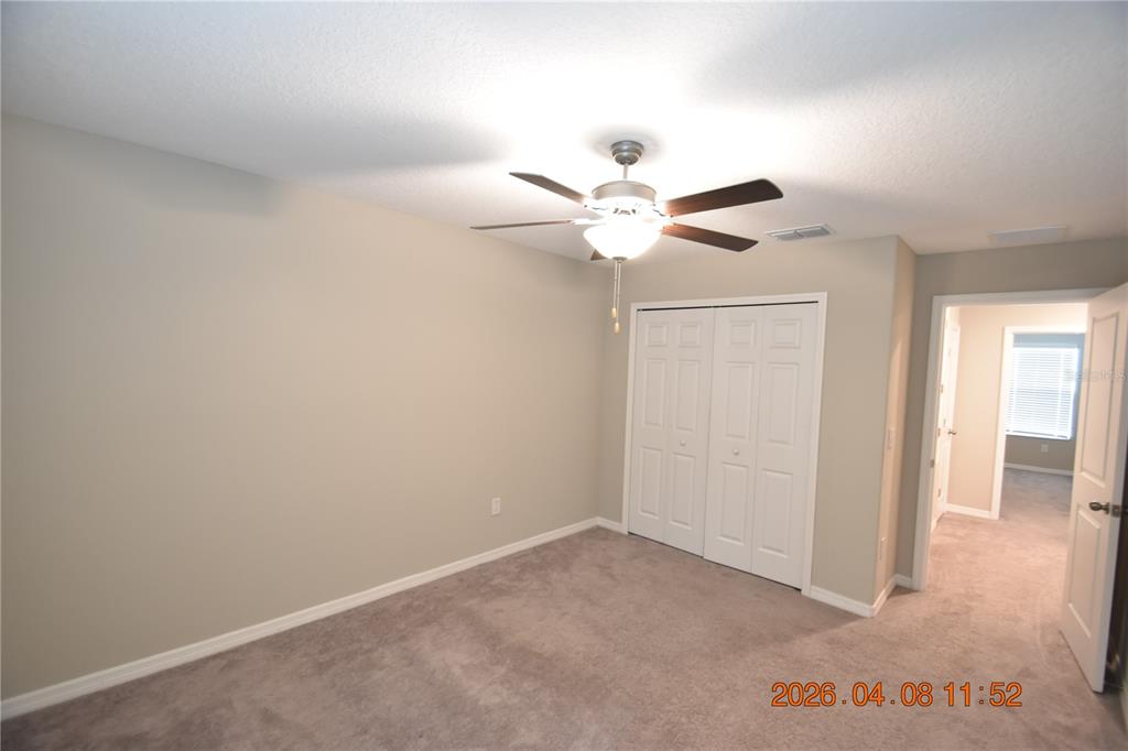 2187 Old Mining Road Lakeland, FL 33801 - Photo 55 of 65 an empty room with a ceiling fan and a window