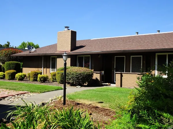 a front view of a house with a yard and porch
