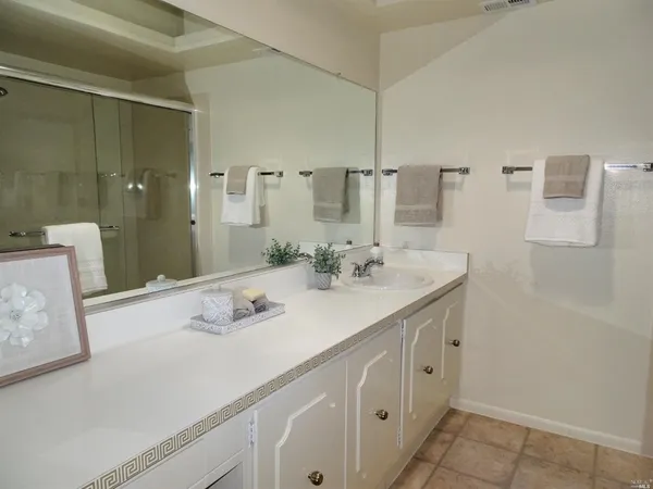 a bathroom with a sink double vanity and a mirror