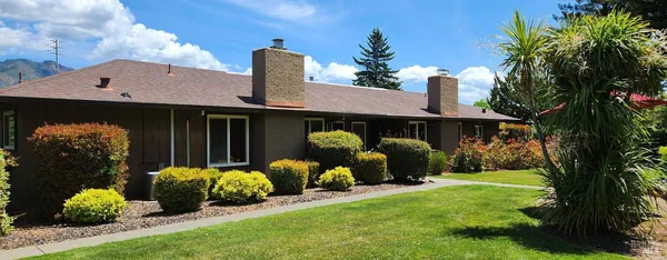 a front view of a house with garden