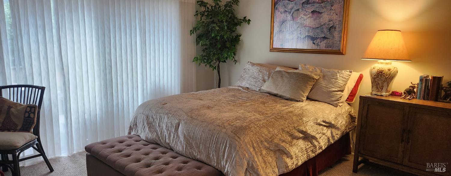 6 Woodgreen Street Santa Rosa, CA 95409 - Photo 10 of 16 a bedroom with a bed and a lamp on dresser