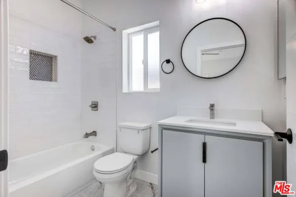 a bathroom with a toilet a sink and a mirror