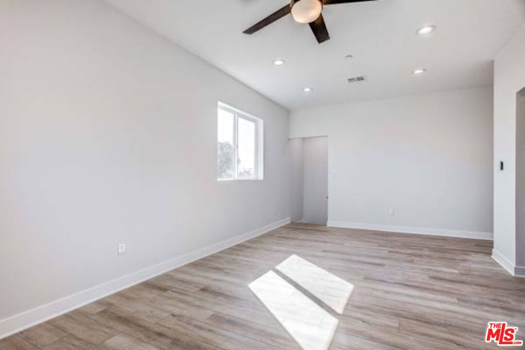 624 West 83rd Street, Unit 624 1/4 Los Angeles, CA 90044 - Photo 4 of 5 wooden floor in an empty room with a window