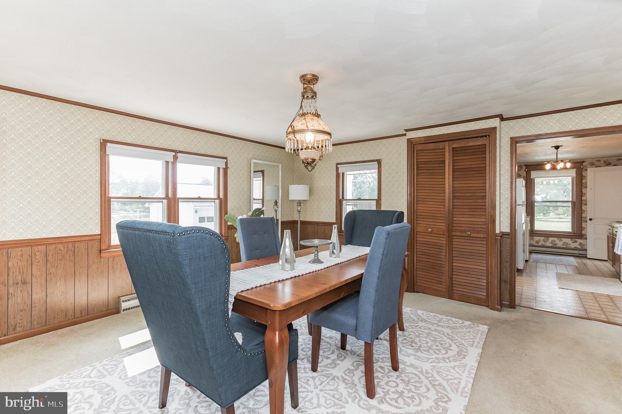 28814 Kemptown Road Damascus, MD 20872 - Photo 8 of 49 a dining room with furniture a chandelier and wooden floor