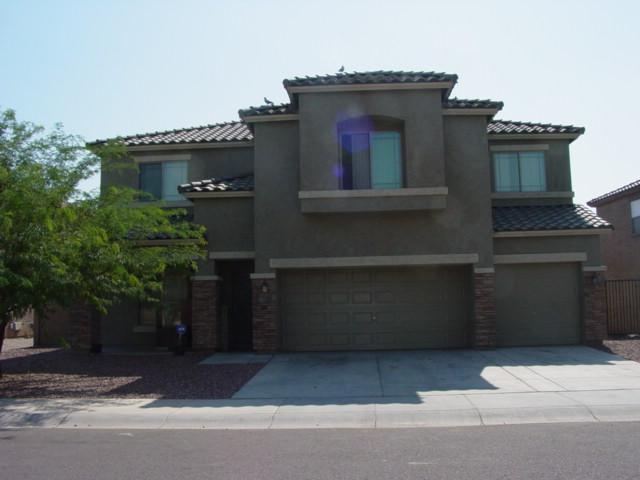 9317 West Rascon Loop Phoenix, AZ 85037 - Photo 1 of 1 a front view of a house