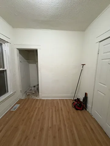 a view of a room with wooden floor and closet