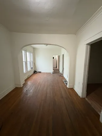 wooden floor in an empty room with a fireplace