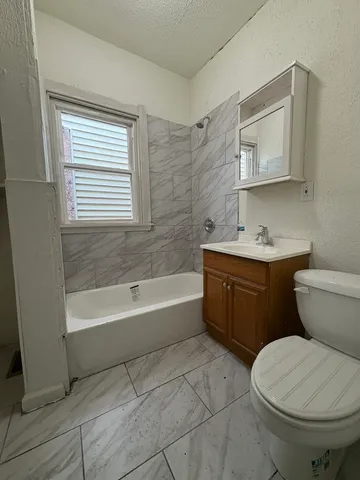 a bathroom with a sink toilet and bathtub