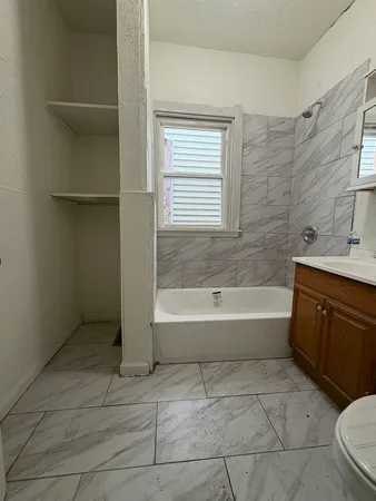 a bathroom with a bathtub sink and toilet