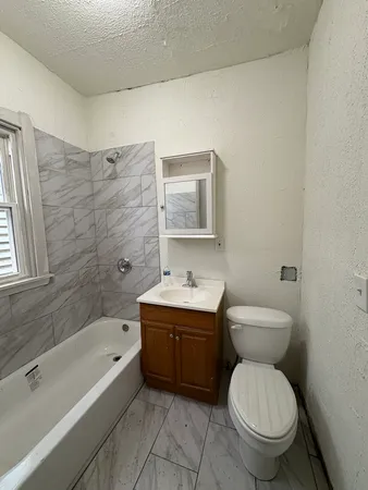 a bathroom with a sink a toilet and bathtub