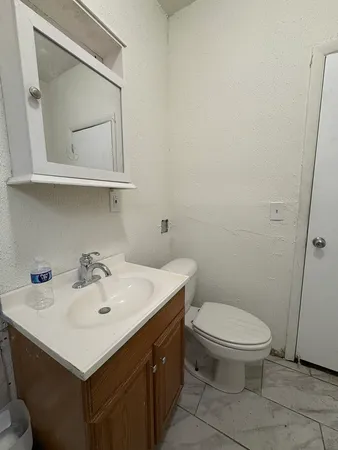 a bathroom with a sink mirror and toilet