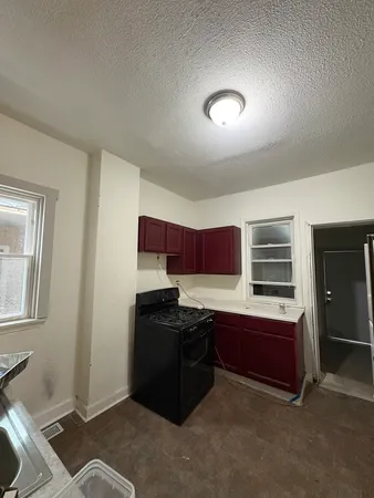 a kitchen with stainless steel appliances granite countertop a stove and a refrigerator