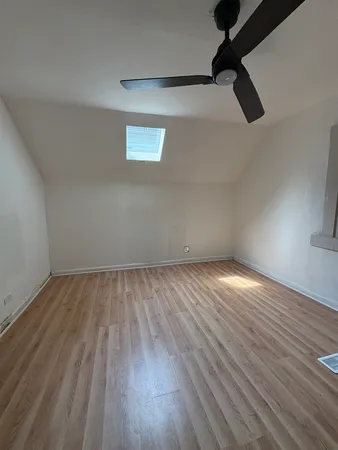 a view of an empty room and wooden floor
