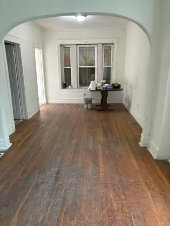 a living room with furniture and large windows
