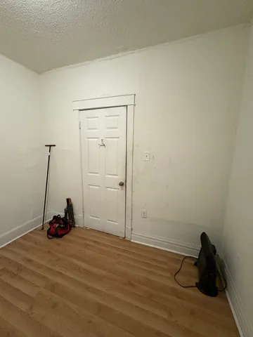 a view of a room with wooden floor and a window