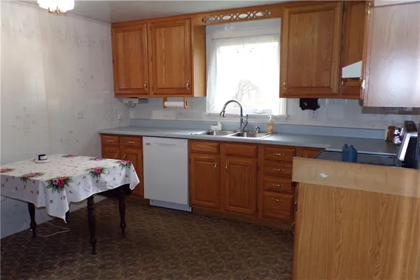 a kitchen with a sink cabinets and wooden floor