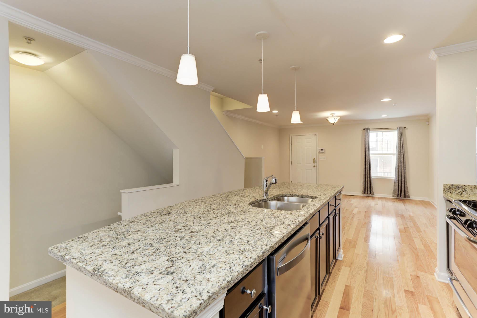 4625 Dillon Place Baltimore, MD 21224 - Photo 11 of 41 Kitchen to living room and stairs to garage