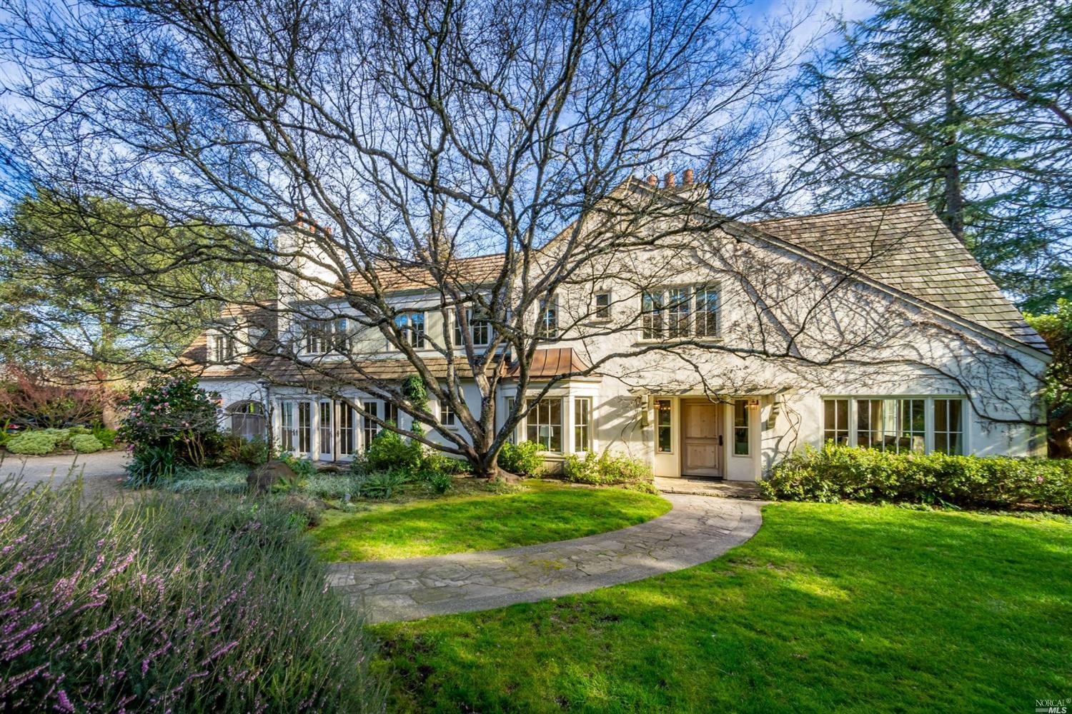 a view of house with yard and green space