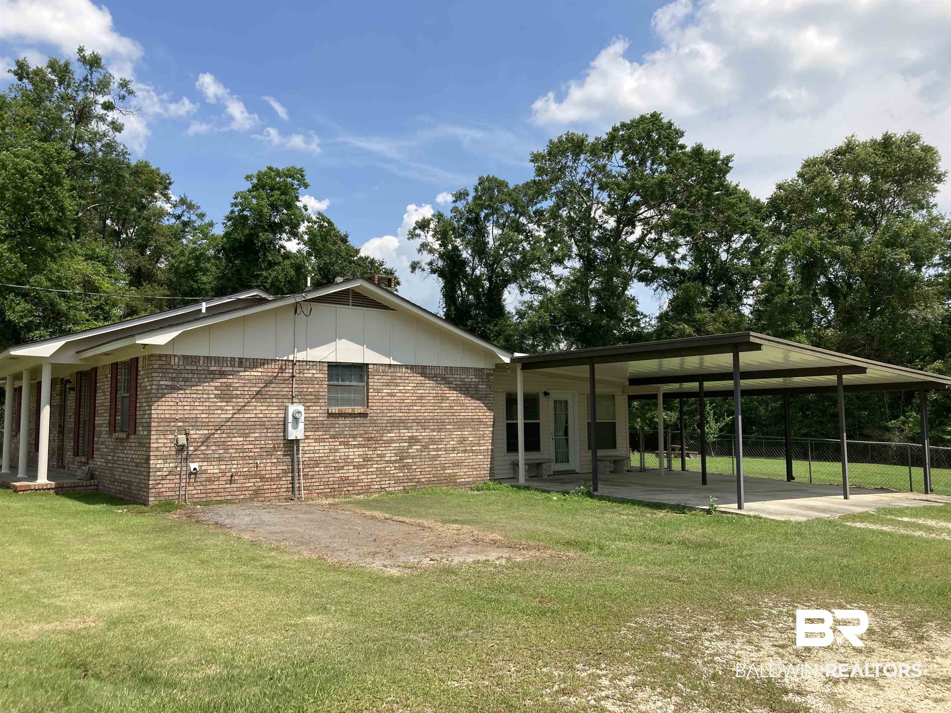 6151 Meadows Road Walnut Hill, FL 32568 - Photo 26 of 29 Back of house featuring a lawn and a carport