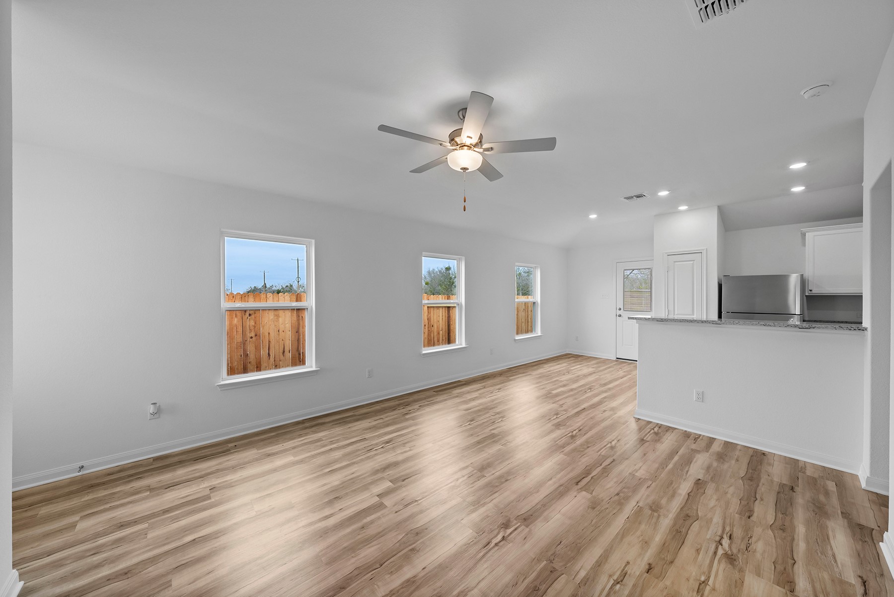 18420 Stellers Sea Street Elgin, TX 78621 - Photo 2 of 9 Enjoy a bright sprawling family room, open to the dining room and kitchen, creating the ideal space for entertaining.
