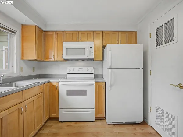 a kitchen with a refrigerator sink stove and cabinets