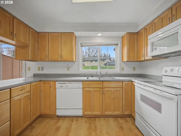 a kitchen with stainless steel appliances granite countertop a sink and cabinets