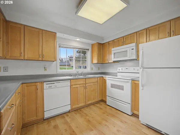 a kitchen with stainless steel appliances granite countertop a refrigerator sink stove and microwave